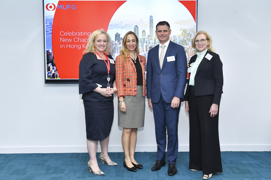 Four people standing in front of MUFG Hong Kong sign